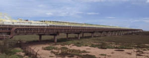 Side elevation of piggy-back conveyor showing truss on top of original structure.
