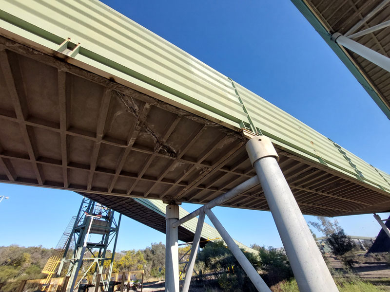 Pre-existing concrete cracking on conveyor gantry slabs inspected following seismic events.