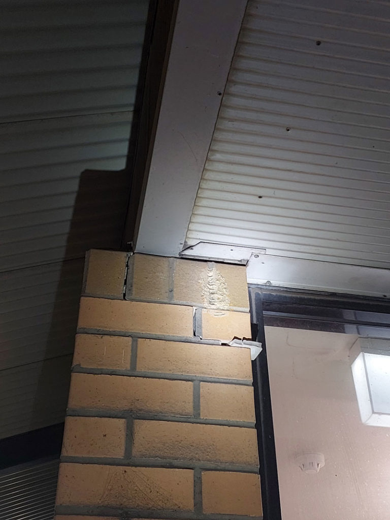 Displaced brickwork and cracked mortar joints indicating structural movement after an earthquake.